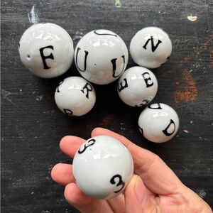set of seven ceramic decorative balls with letters